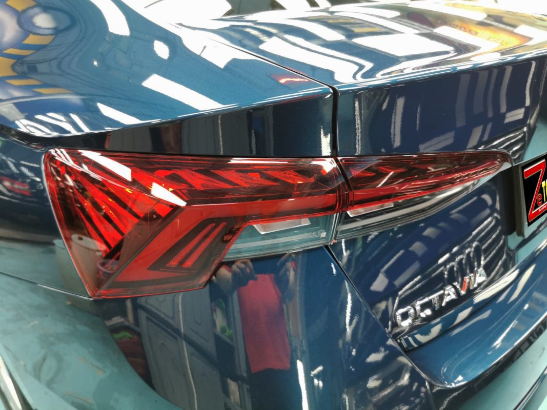 The coated bonnet of the Skoda Octavia under workshop lighting.
