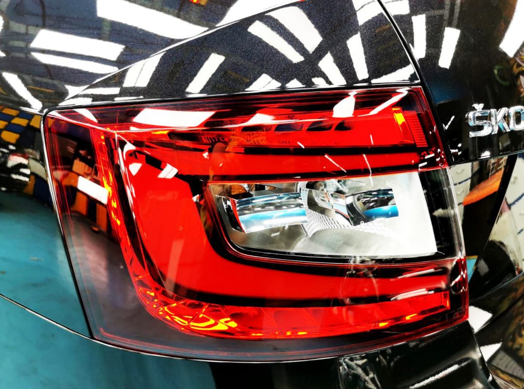 The coated bonnet of the Skoda Octavia under workshop lighting.