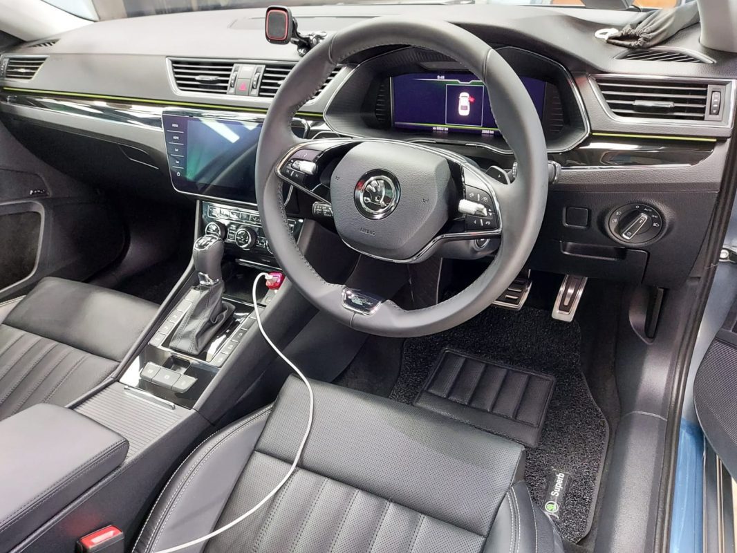 The Skoda Superb parked in the workshop, freshly coated.