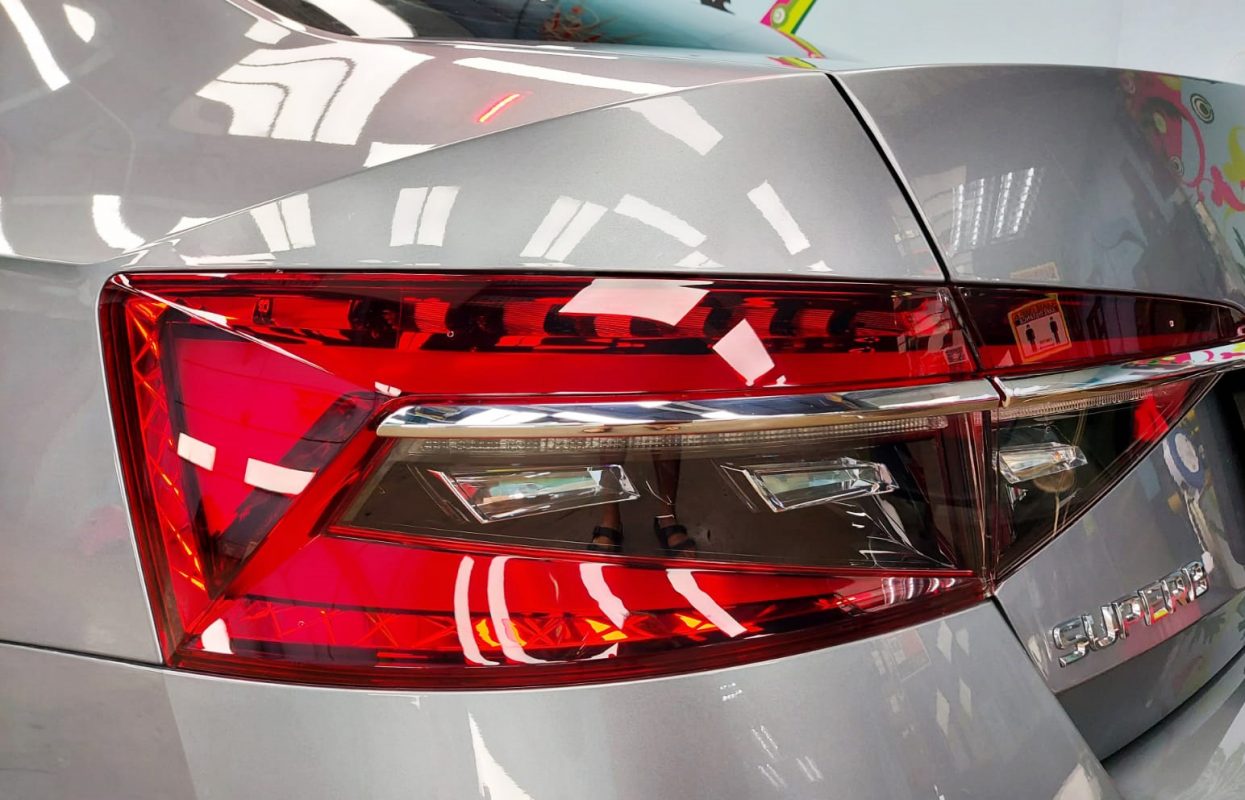 The coated bonnet of the Skoda Superb under workshop lighting.