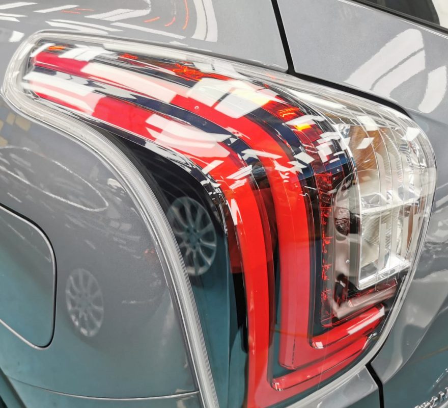 The coated bonnet of the SsangYong Tivoli under workshop lighting.