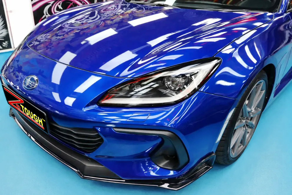The Subaru BRZ's coated paintwork under workshop lighting.