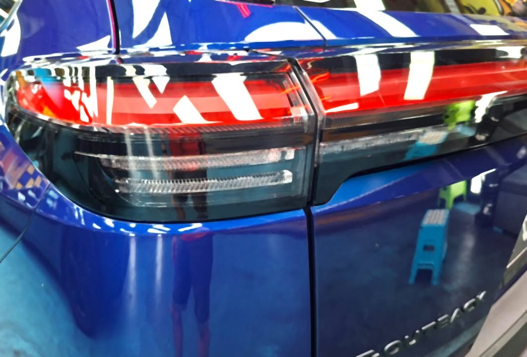 Close-up of the Subaru E-Outback tail light and blue tailgate.