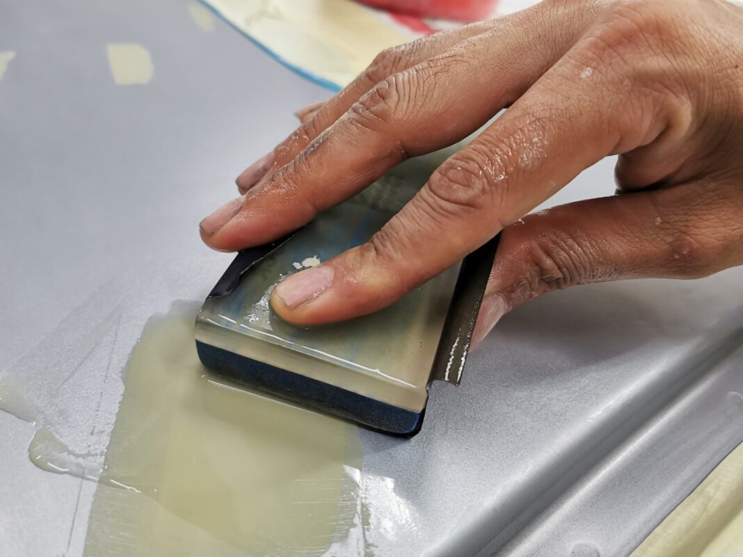 Wet-sanding the Forester's panels to smooth the existing paintwork.
