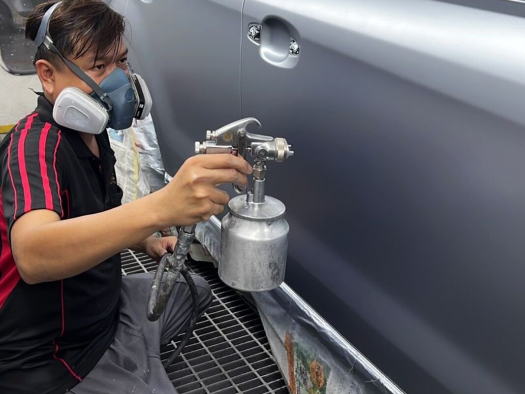 The Forester being wet-sanded and polished after spraying.