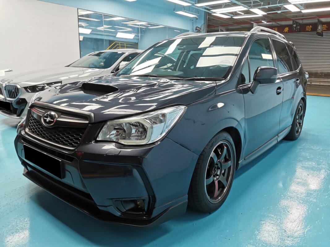 The Subaru Forester as it arrived at Revol Carz, front view showing faded and damaged paintwork.