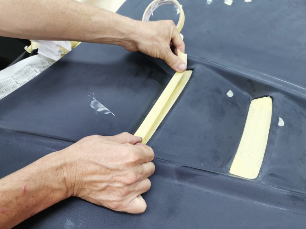 The Subaru Forester masked up, non-painted surfaces covered before the spray booth.