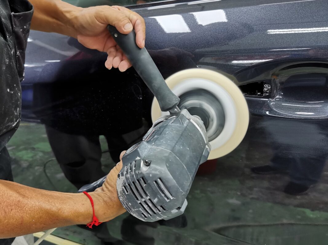 Machine-polishing the Subaru Forester's freshly painted surface to bring up the gloss.