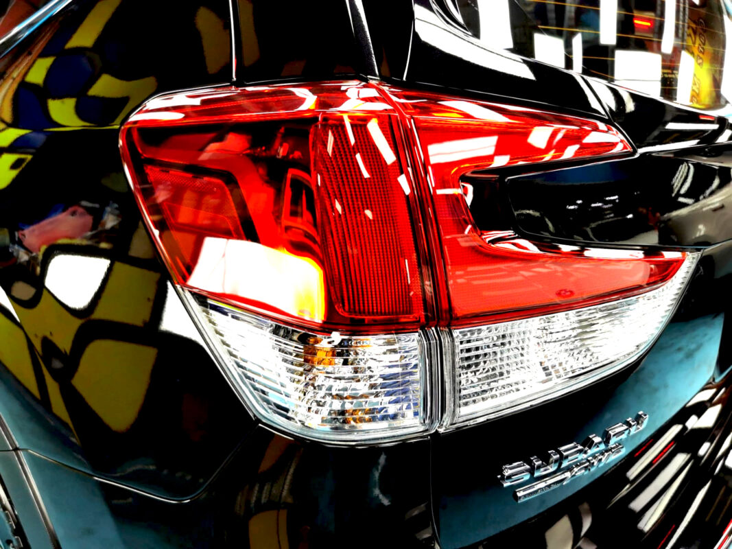 The coated bonnet of the Subaru Forester under workshop lighting.