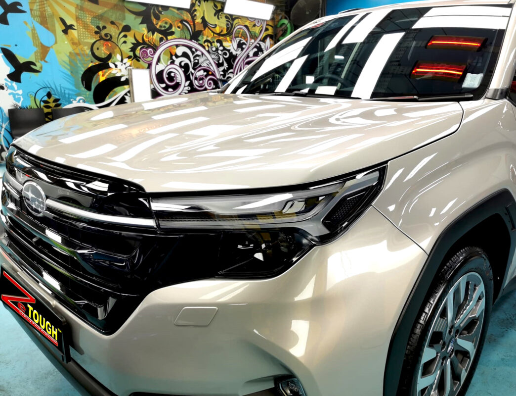 The Subaru Forester's coated paintwork under workshop lighting.