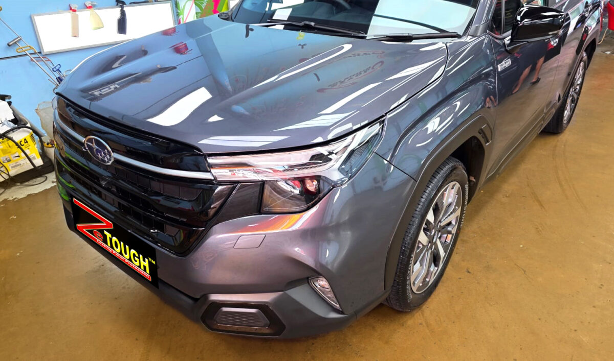 The Subaru Forester's coated paintwork under workshop lighting.