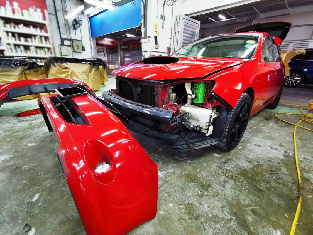 The Subaru Impreza at an early stage of the job, with parts being dismantled.