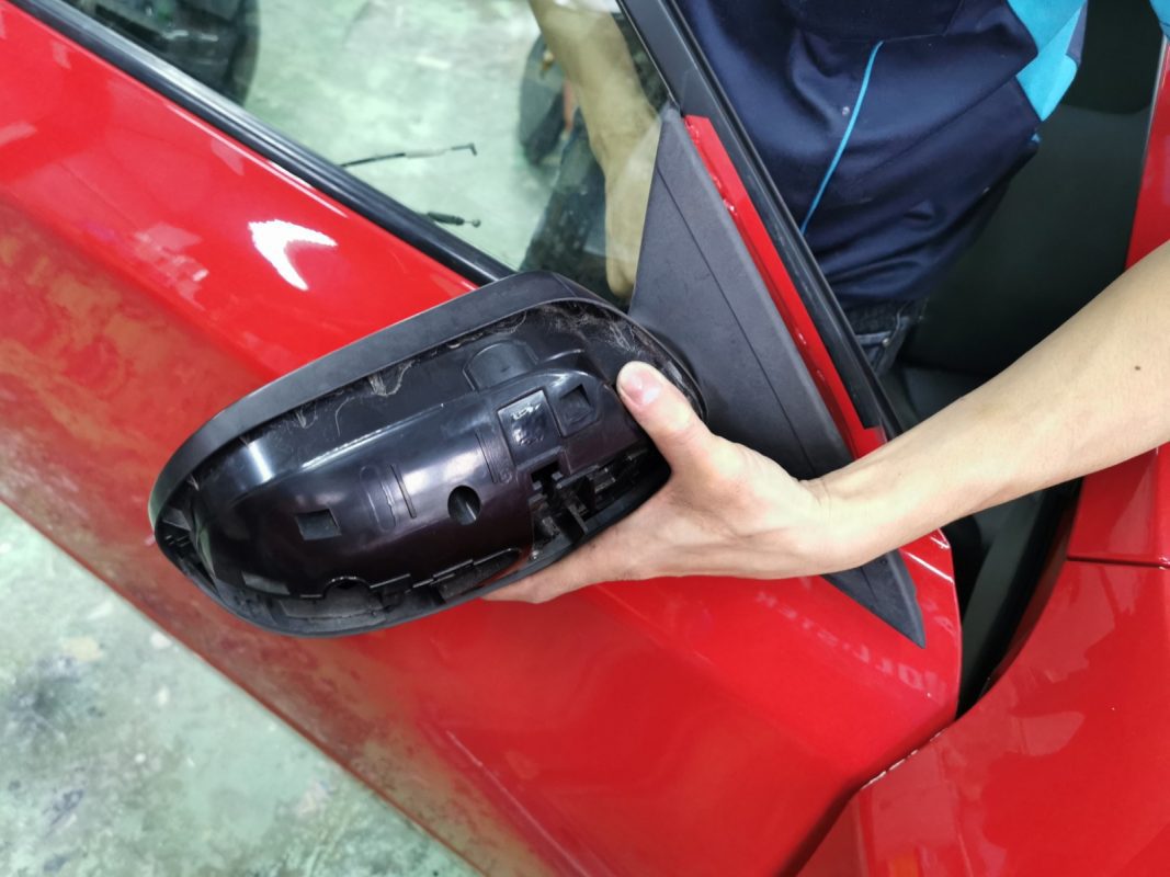 Previously removed car parts being refitted onto the Impreza.