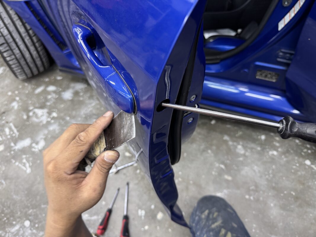 Car parts being dismantled from the Subaru WRX in preparation for spraying.