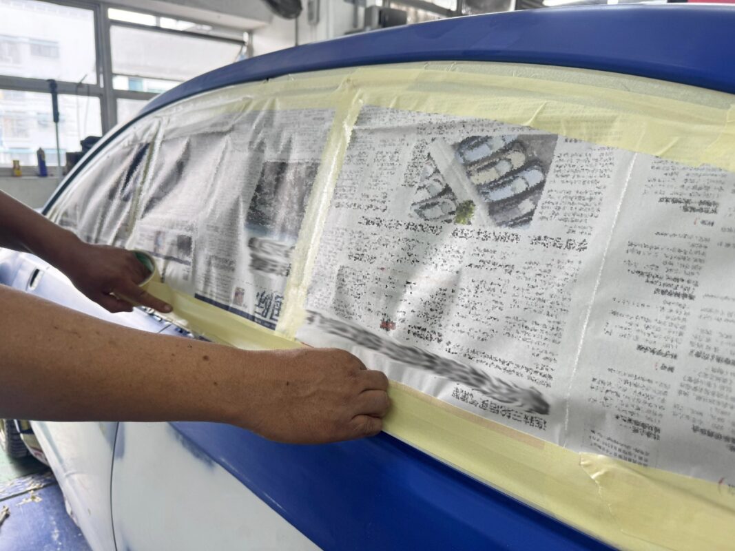 Non-painted surfaces being masked off on the Subaru WRX.