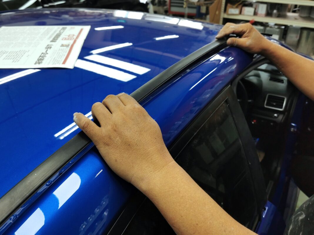 Previously removed car parts being refitted onto the Subaru WRX.