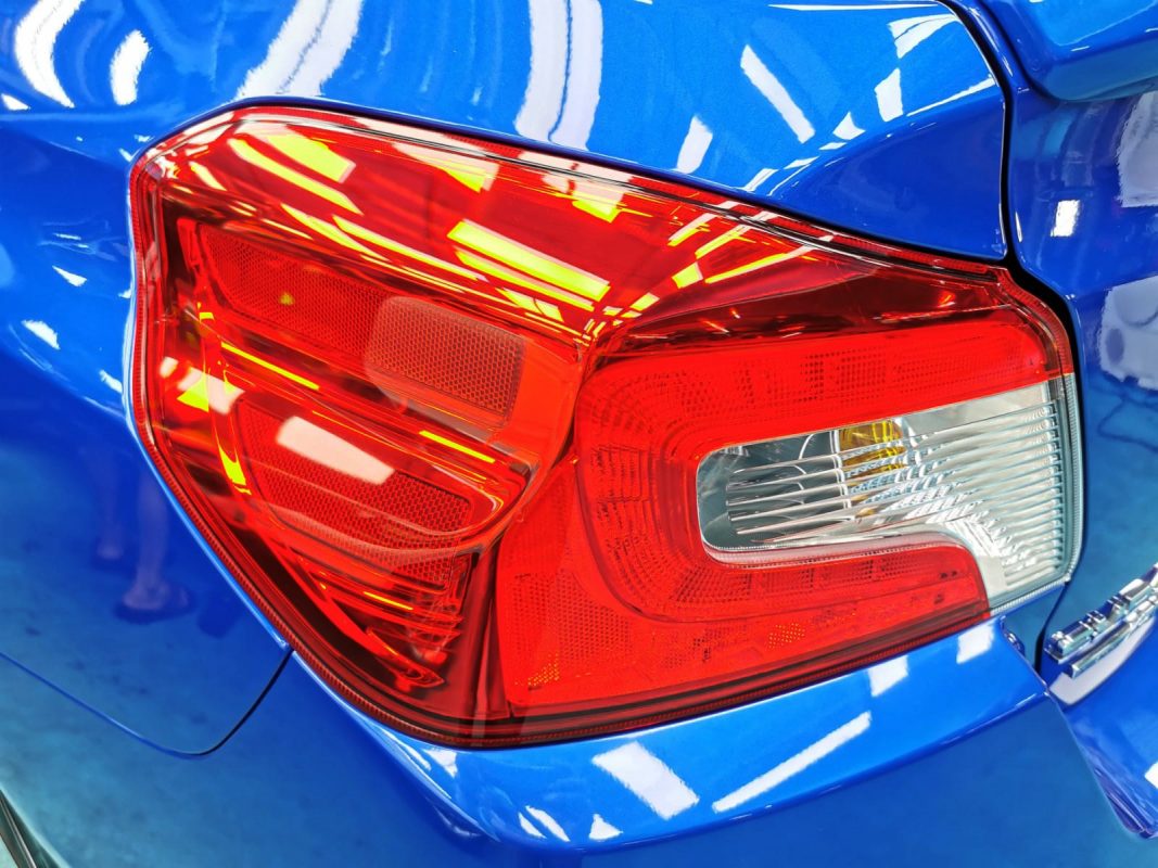 The coated bonnet of the Subaru WRX under workshop lighting.
