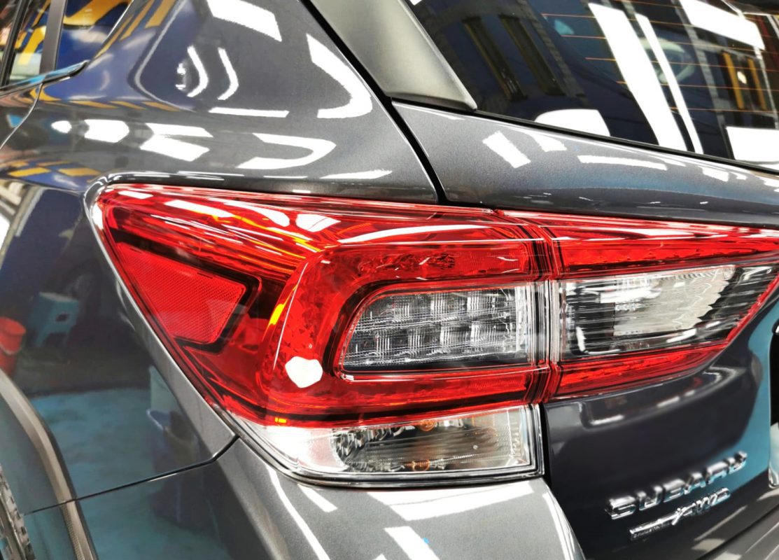 The coated bonnet of the Subaru XV under workshop lighting.