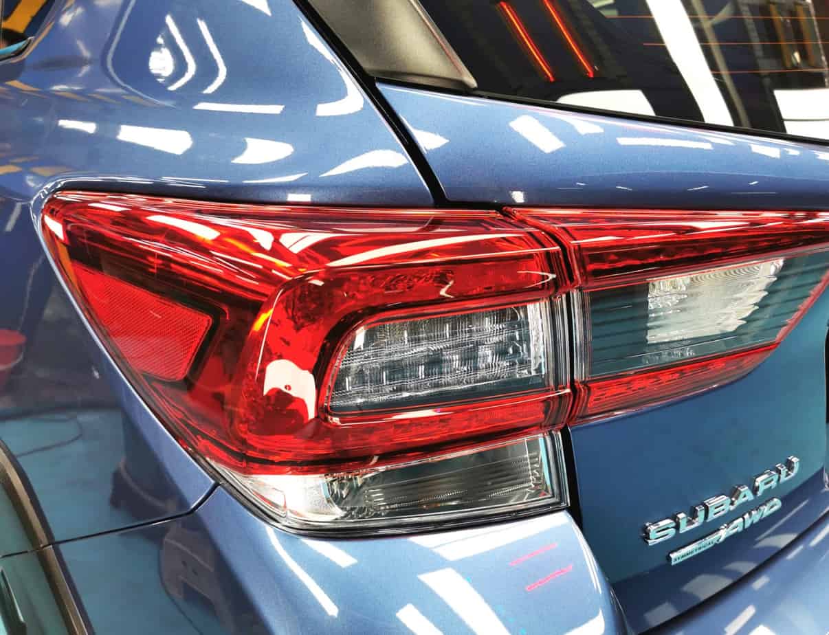 The coated bonnet of the Subaru XV under workshop lighting.