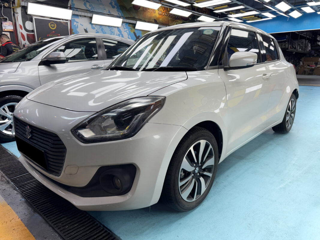 The Suzuki Swift as it arrived at Revol Carz, showing paint peel and scratches before the respray.