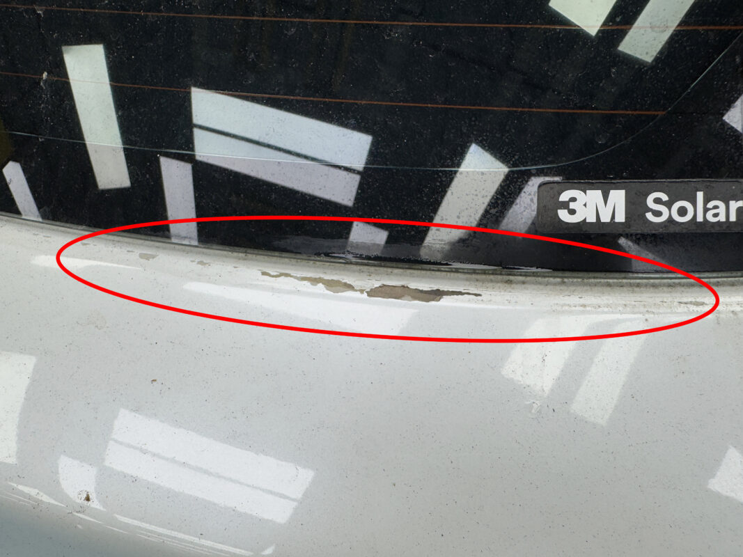 A side view of the Suzuki Swift on arrival, damage visible across the bodywork.