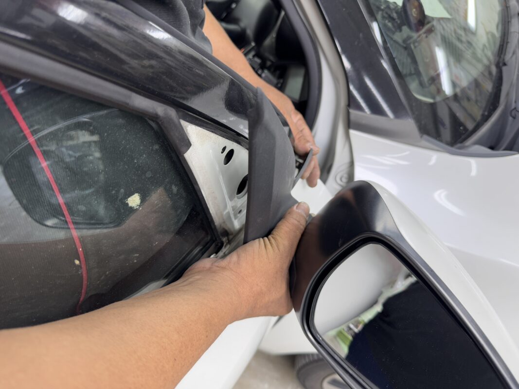The Suzuki Swift's panels further stripped, bodywork exposed for inspection.