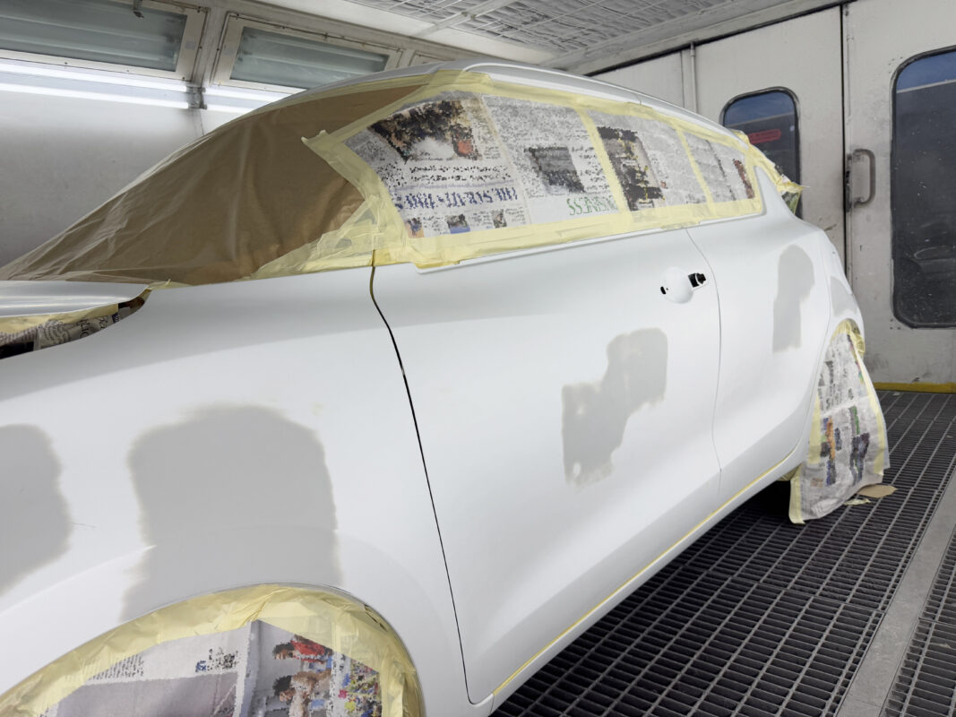 The Suzuki Swift masked up with paper and tape before entering the spray booth.