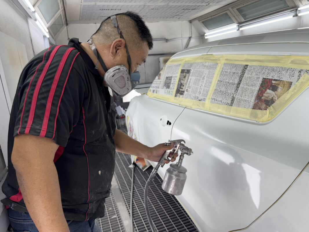 Machine-polishing the Suzuki Swift after spraying to bring up the gloss.