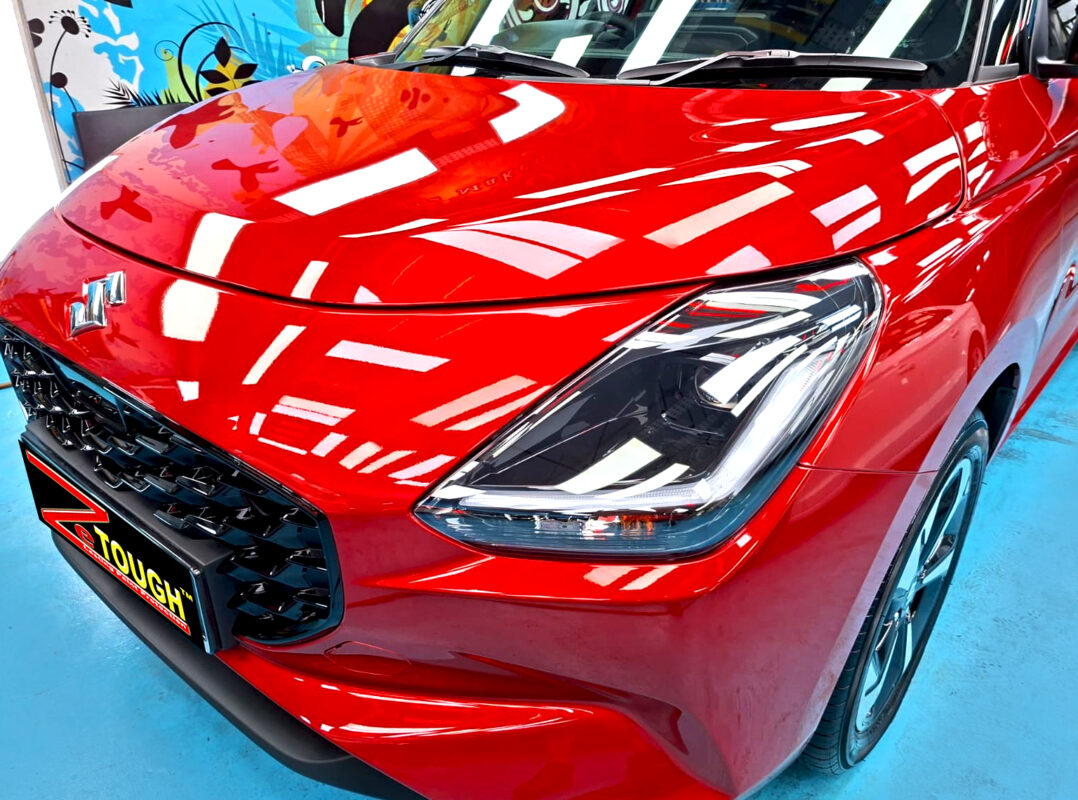 The Suzuki Swift's coated paintwork under workshop lighting.