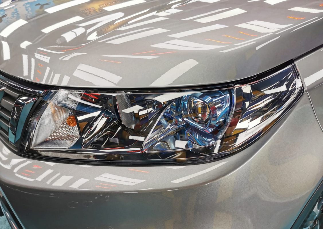 The Vitara's coated paintwork showing clean reflections.