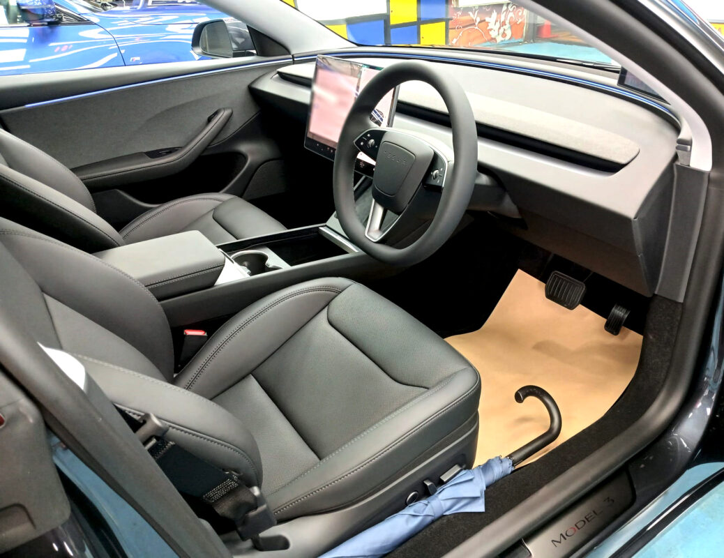 The Tesla Model 3 parked in the workshop, freshly coated.