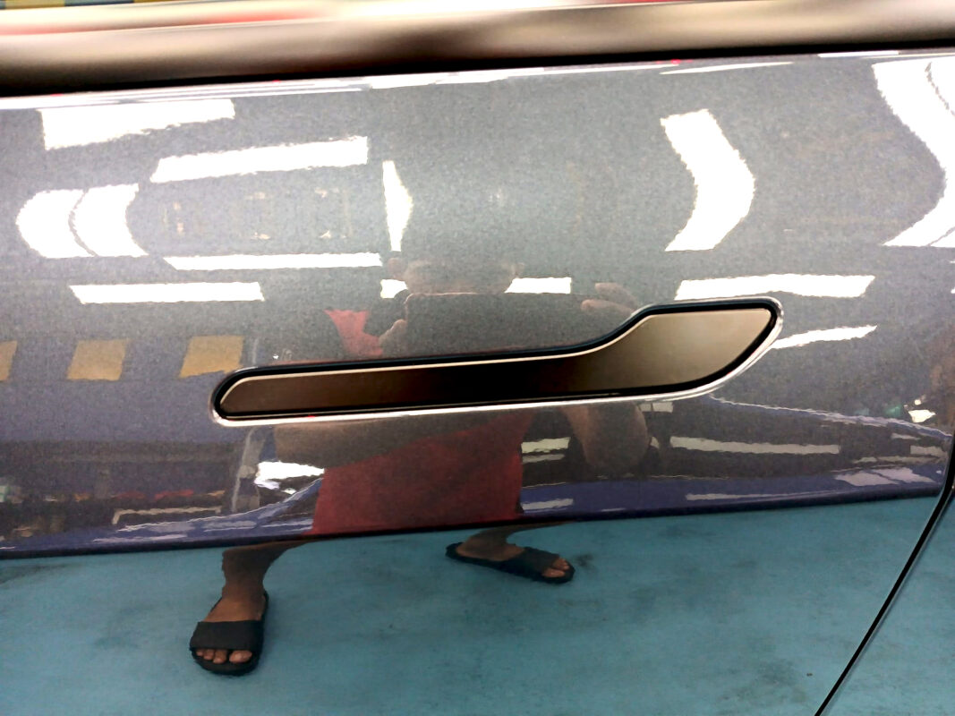 Front three-quarter view of the Tesla Model 3 after coating.