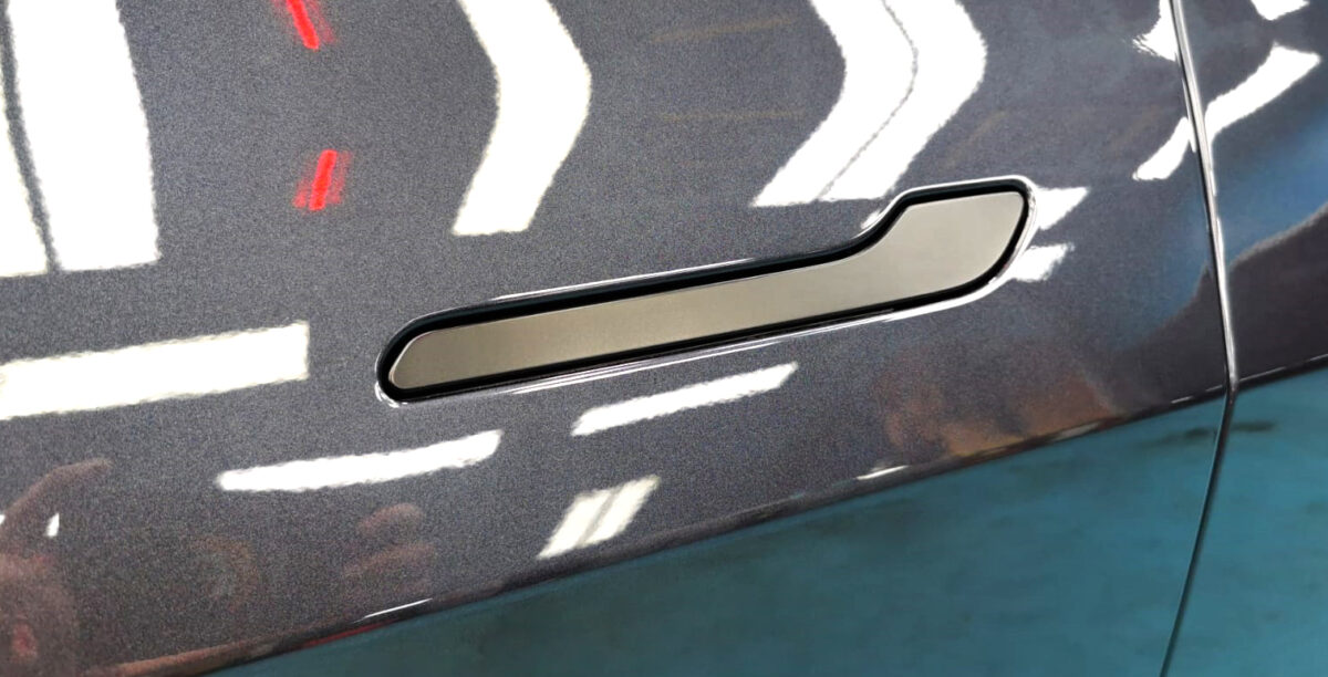 Front three-quarter view of the Tesla Model 3 after coating.