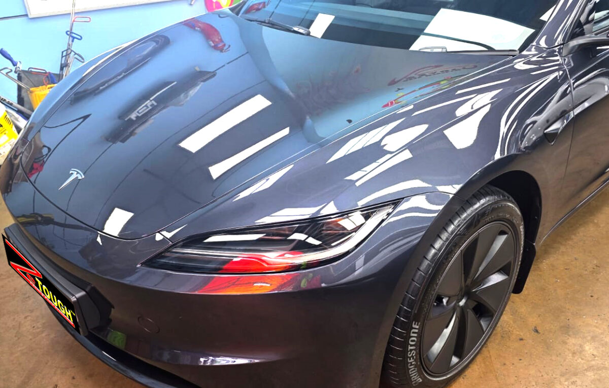 The Tesla Model 3 from a side angle after the ceramic coating.