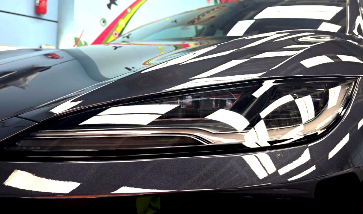 The Model 3's coated paintwork showing clean reflections.