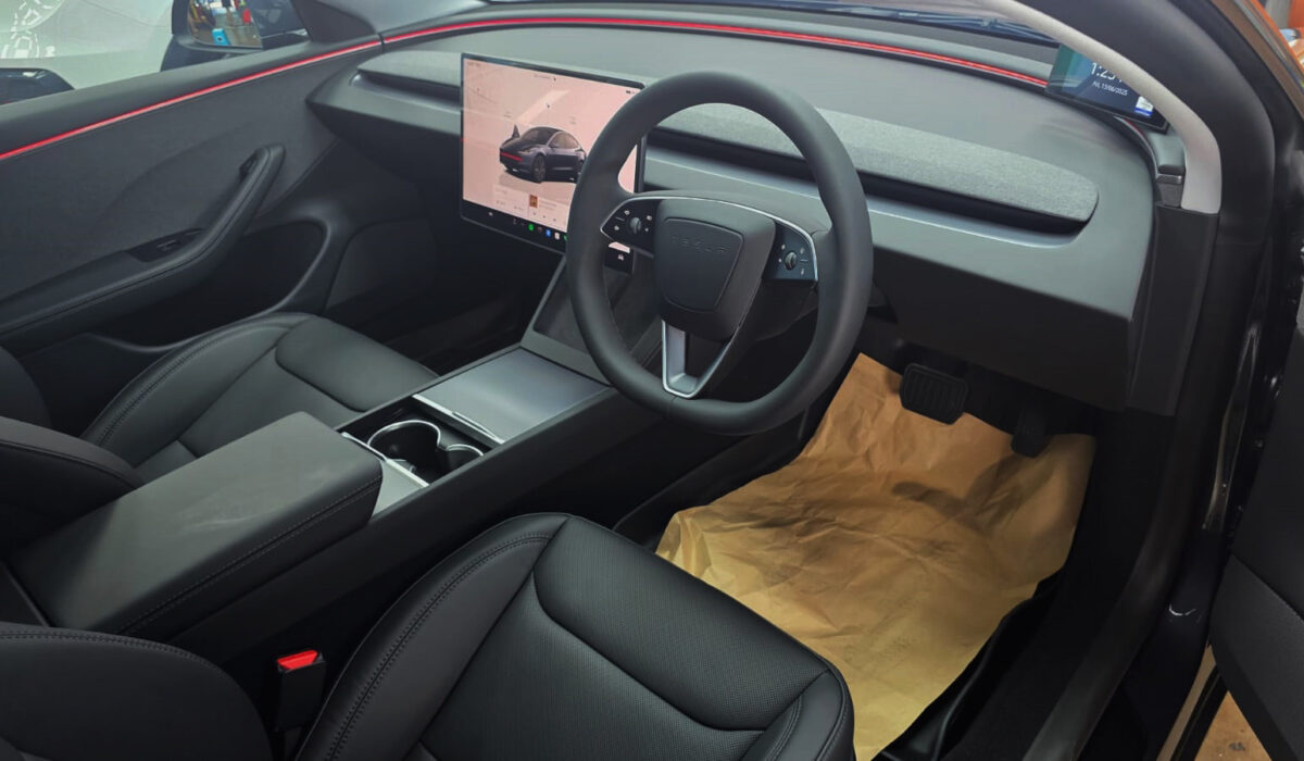 The Tesla Model 3 parked in the workshop, freshly coated.
