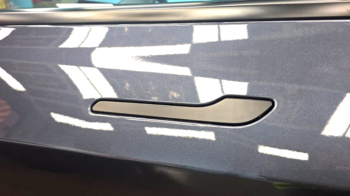 Front three-quarter view of the Tesla Model 3 after coating.