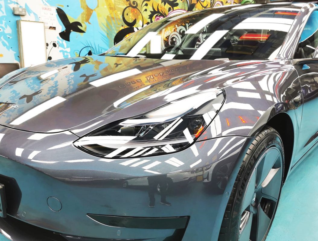 The Tesla Model 3 from a side angle after the titanium coating.
