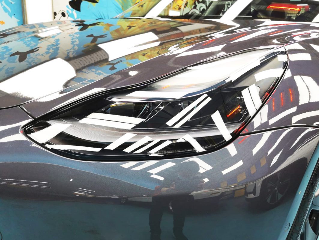 The Model 3's coated paintwork showing clean reflections.