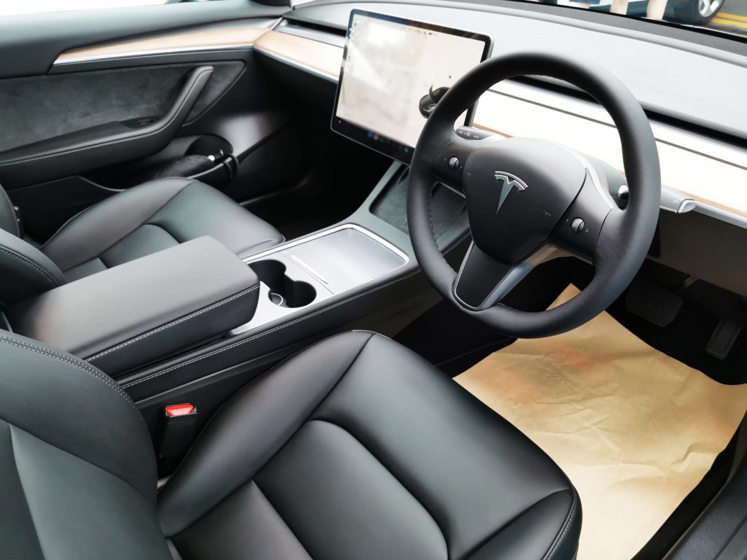 The Tesla Model 3 parked in the workshop, freshly coated.