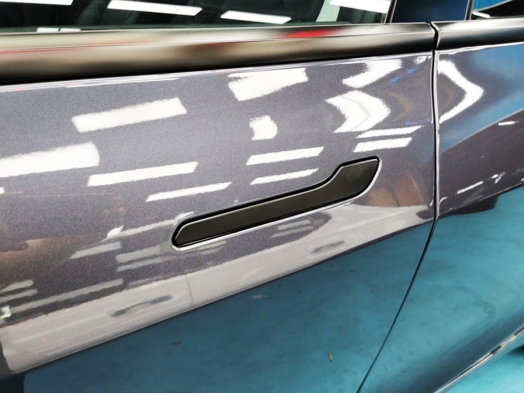 Front three-quarter view of the Tesla Model 3 after coating.
