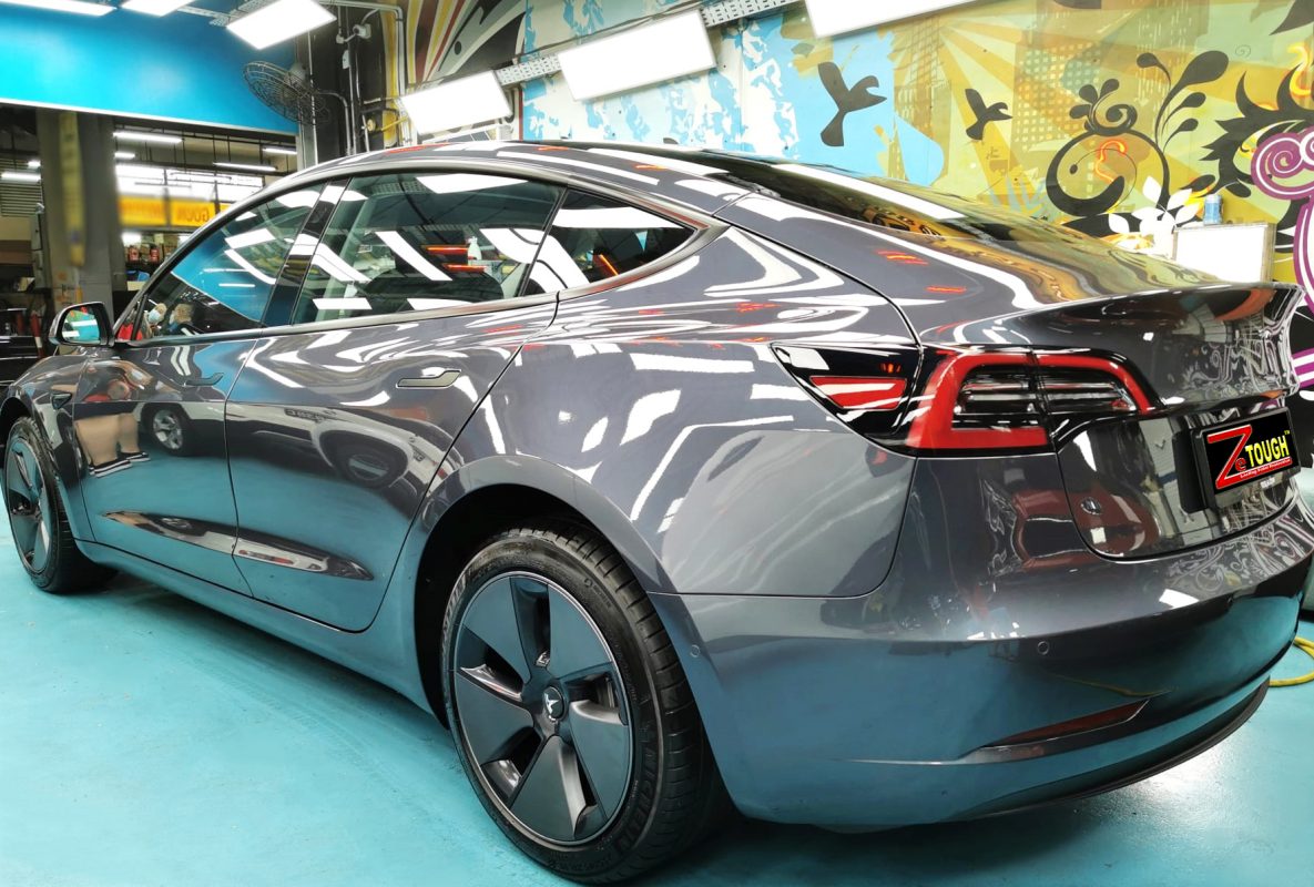 Rear quarter of the Model 3, glossy and protected.