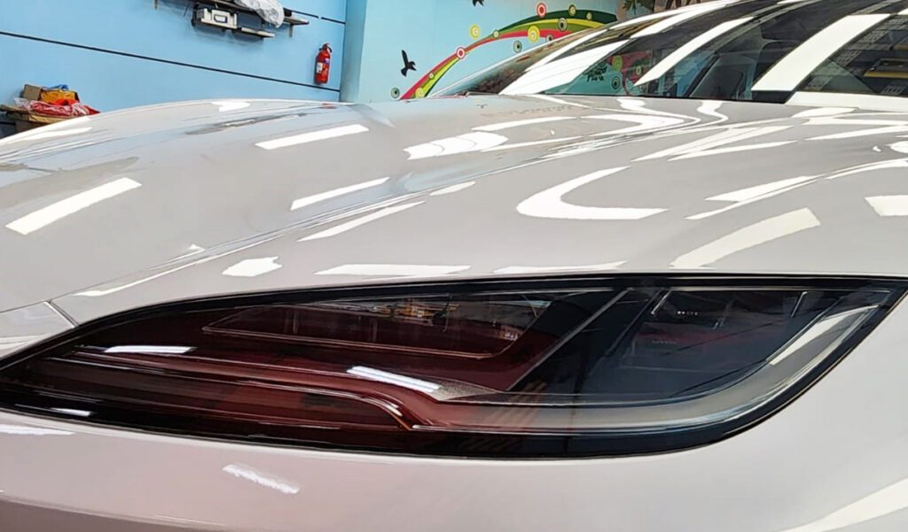 The Tesla Model 3 from a side angle after the titanium coating.
