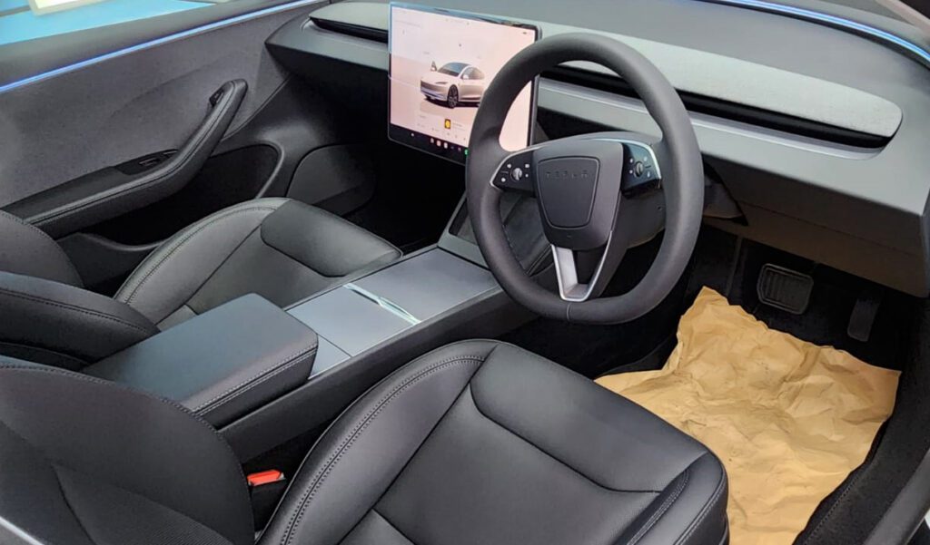 The Model 3's coated paintwork showing clean reflections.