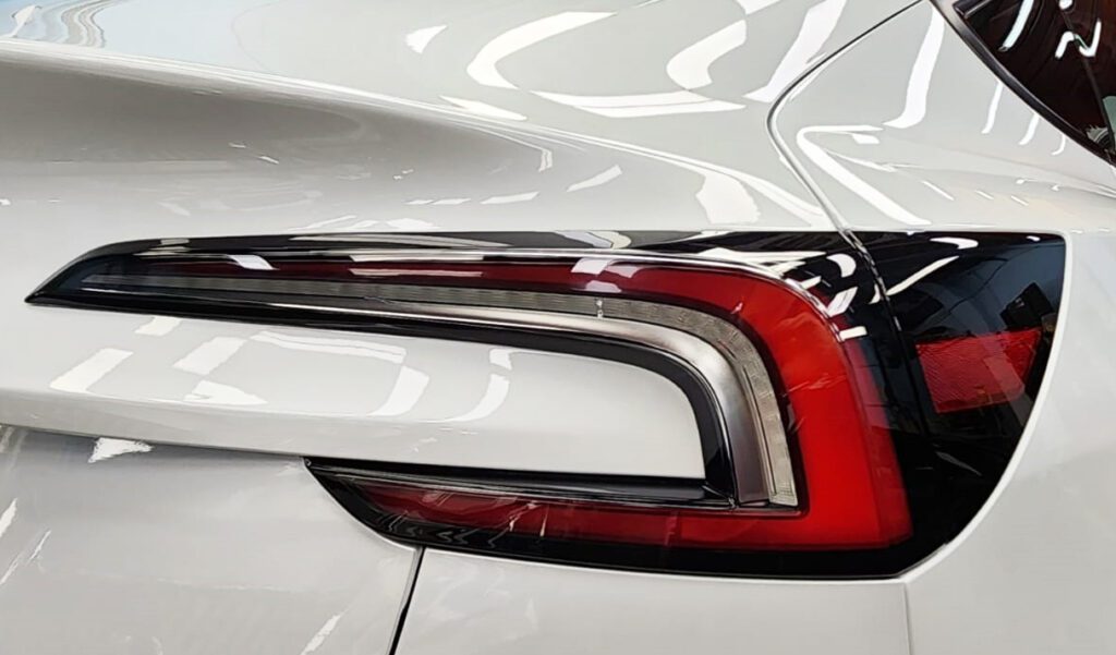 Rear quarter of the Tesla Model 3, glossy and protected.
