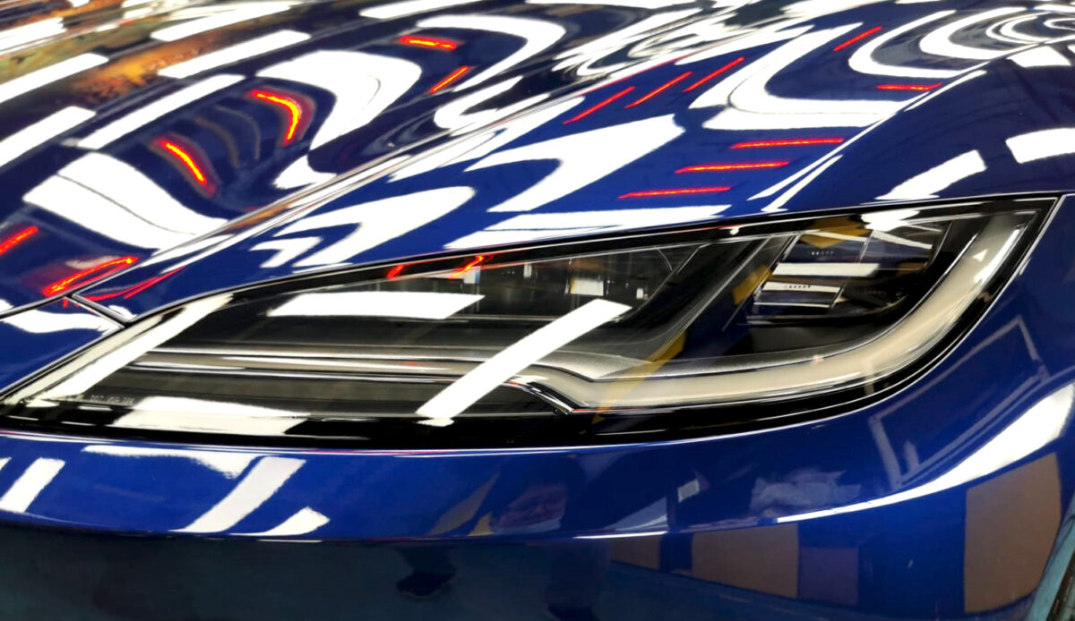The Model 3's coated paintwork showing clean reflections.