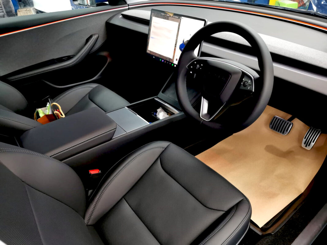The Tesla Model 3 parked in the workshop, freshly coated.