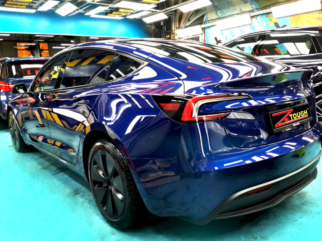 Rear quarter of the Tesla Model 3, glossy and protected.