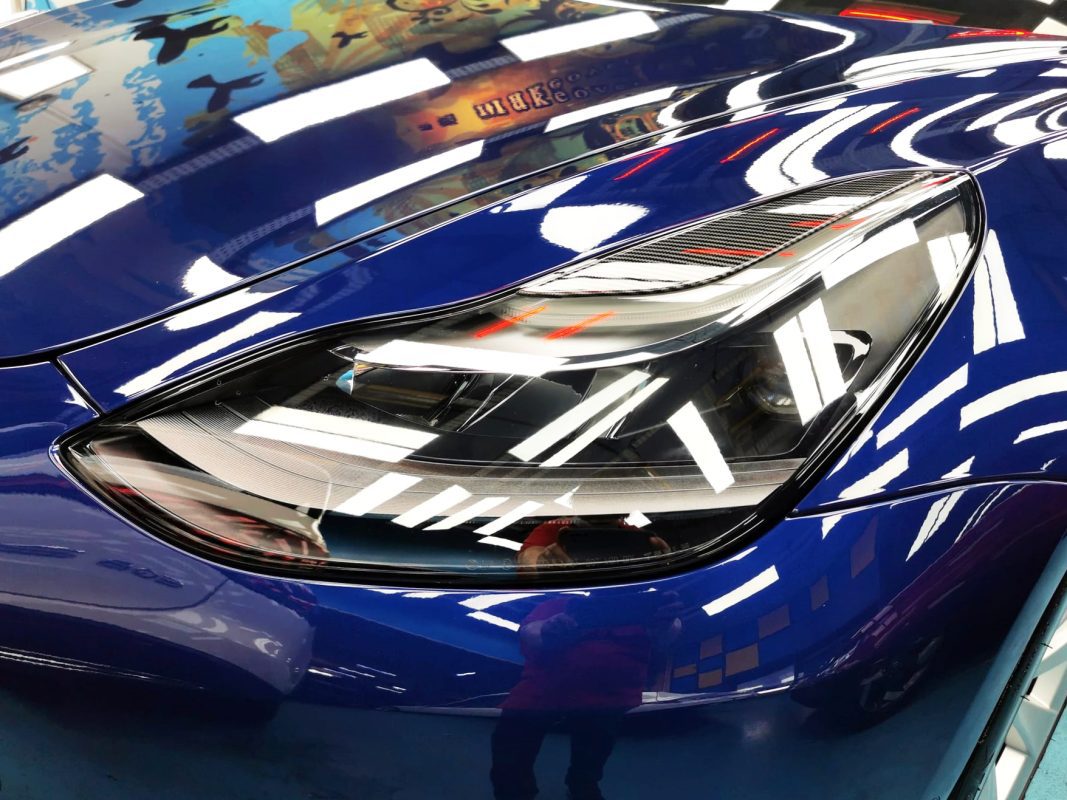 The Model 3's coated paintwork showing clean reflections.