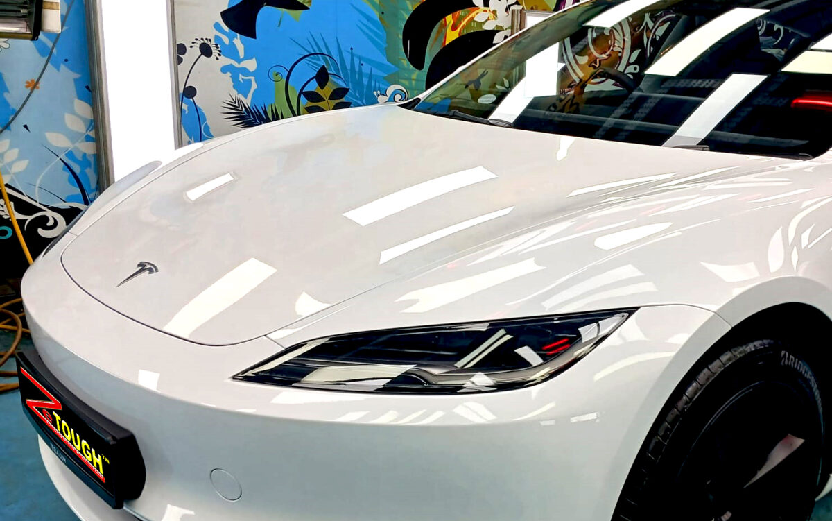 The Tesla Model 3 from a side angle after the ceramic coating.